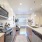 Modern apartment kitchen with open floor plan and stainless steel appliances in Lakewood, Colorado.