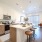 Bright kitchen with light wood cabinets and white counters inside Lakewood apartments.