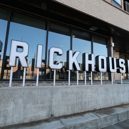 Love Where You Live Brickhouse apartment building exterior with bold letter signage.