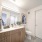Loon floor plan bathroom with light wood cabinets and large linen closet in Lakewood CO apartments