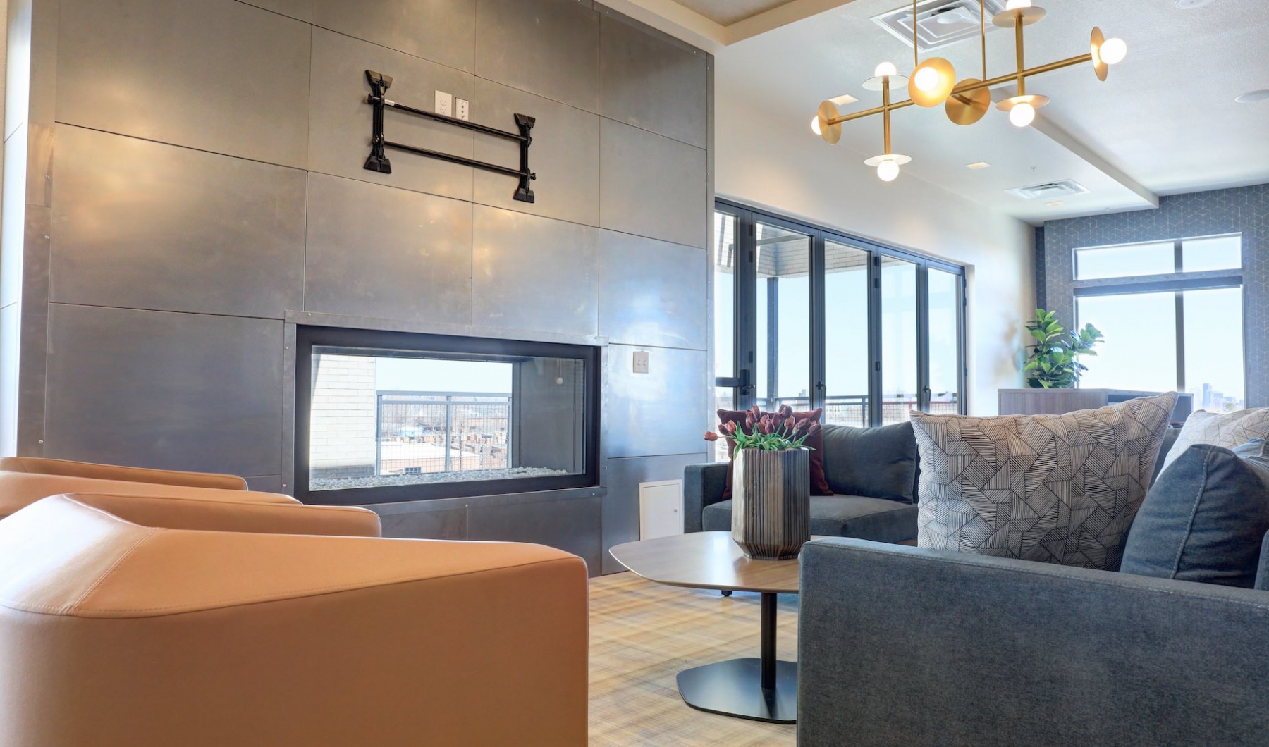 Living Begins Here View lounge with fireplace, cozy seating and funky lighting