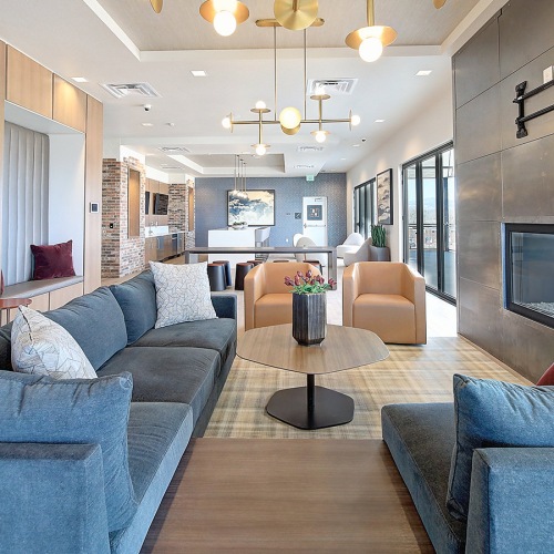 Your new home is waiting Spacious clubhouse lounge with fireplace and seating inside Lakewood apartments.