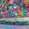 Colorful heart mural on corrugated metal wall with graffiti accents near Lakewood apartments.